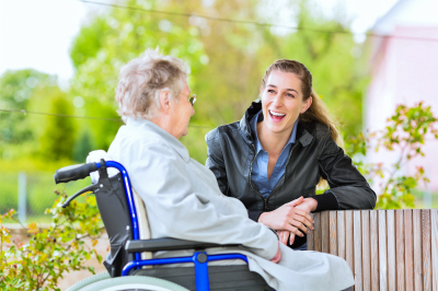 senior woman talking to caregiver
