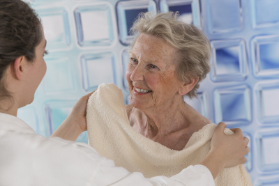 caregiver assisting senior woman for shower